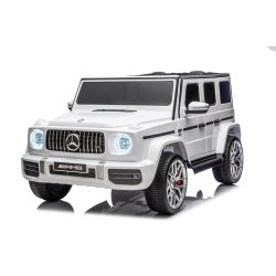 Mașină electrică de jucărie Mercedes-Benz G63 AMG 4x4 cu două locuri, alb, player MP3 cu conexiune USB/AUX și Bluetooth, tractiune 4x4, baterie litiu, roti EVA cu suspensie, scaune din piele artificială, telecomandă, licentă originală